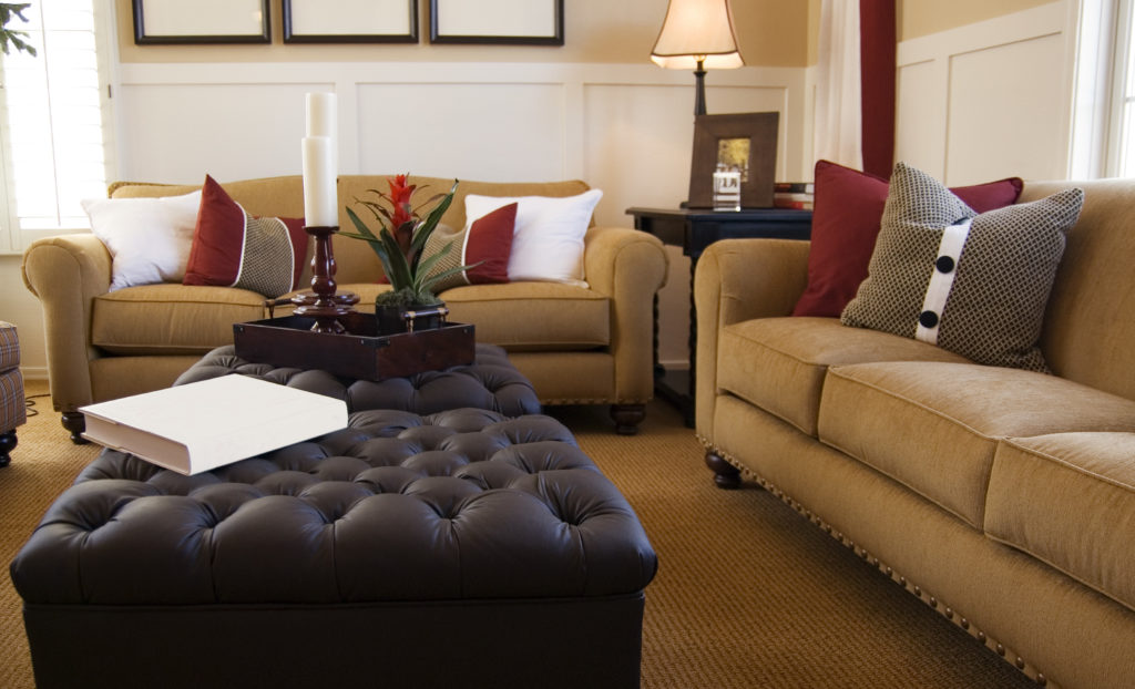 living room furniture with comfortable couches in a beige red and creme color scheme