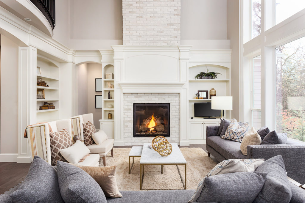 Beautiful living room interior with hardwood floors and fireplace in new luxury home